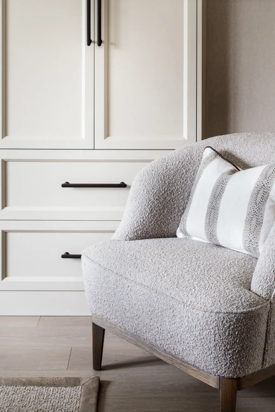 white bespoke wardrobe behind a white soft chair