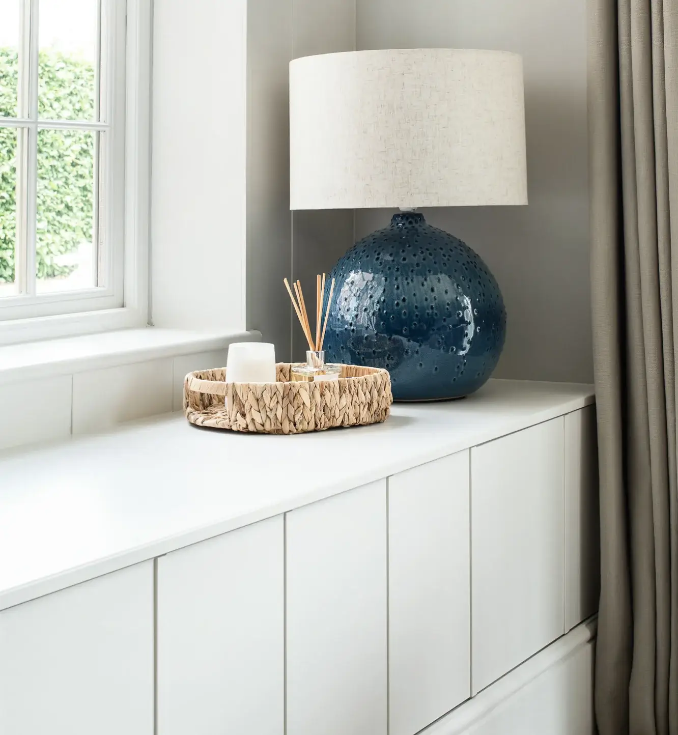 bespoke fitted bench with closed drawers and a lamp on the top