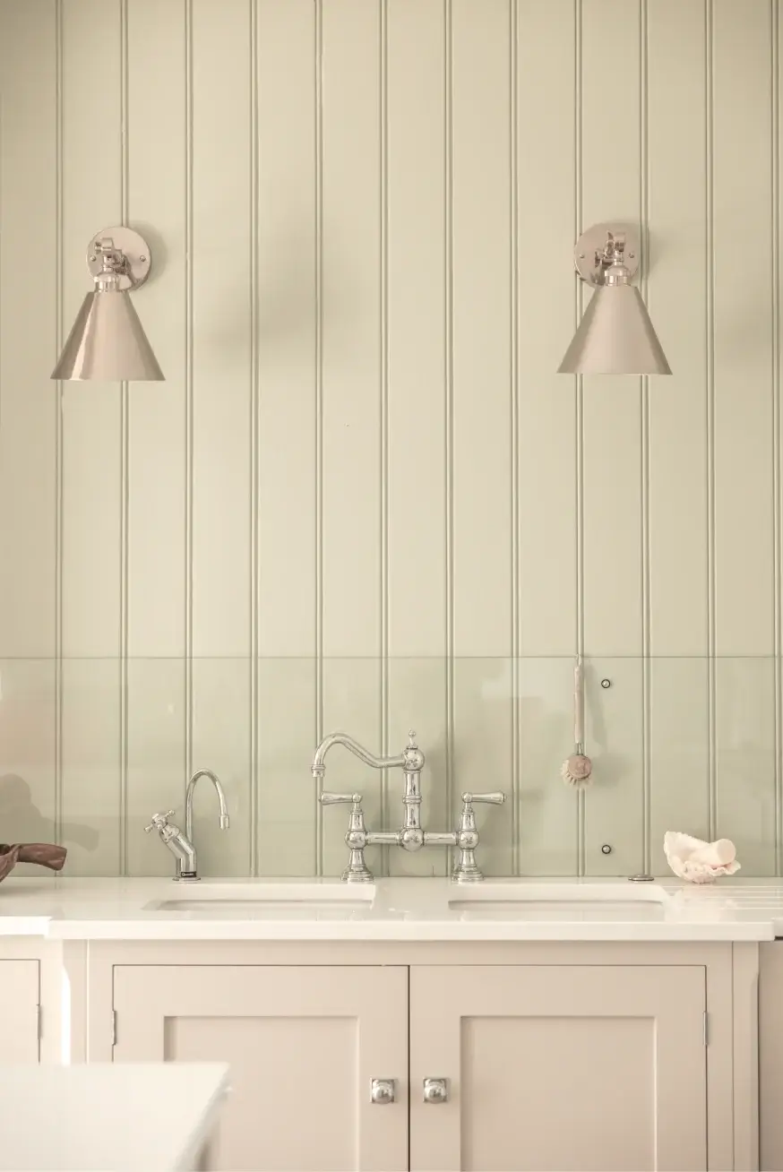 Bespoke Kitchen with cabinetry in off-white and a clad wall behind