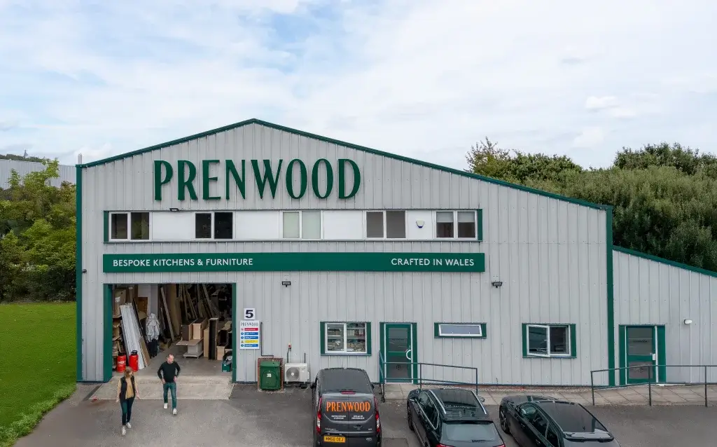 An exterior view of the Prenwood workshop with Helen and Simon walking out the front.