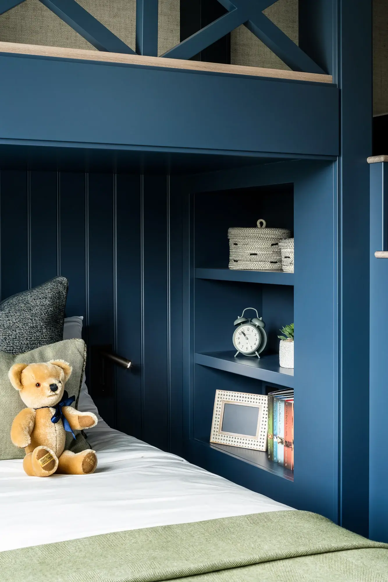 Alcove with shelves under bunk bed steps