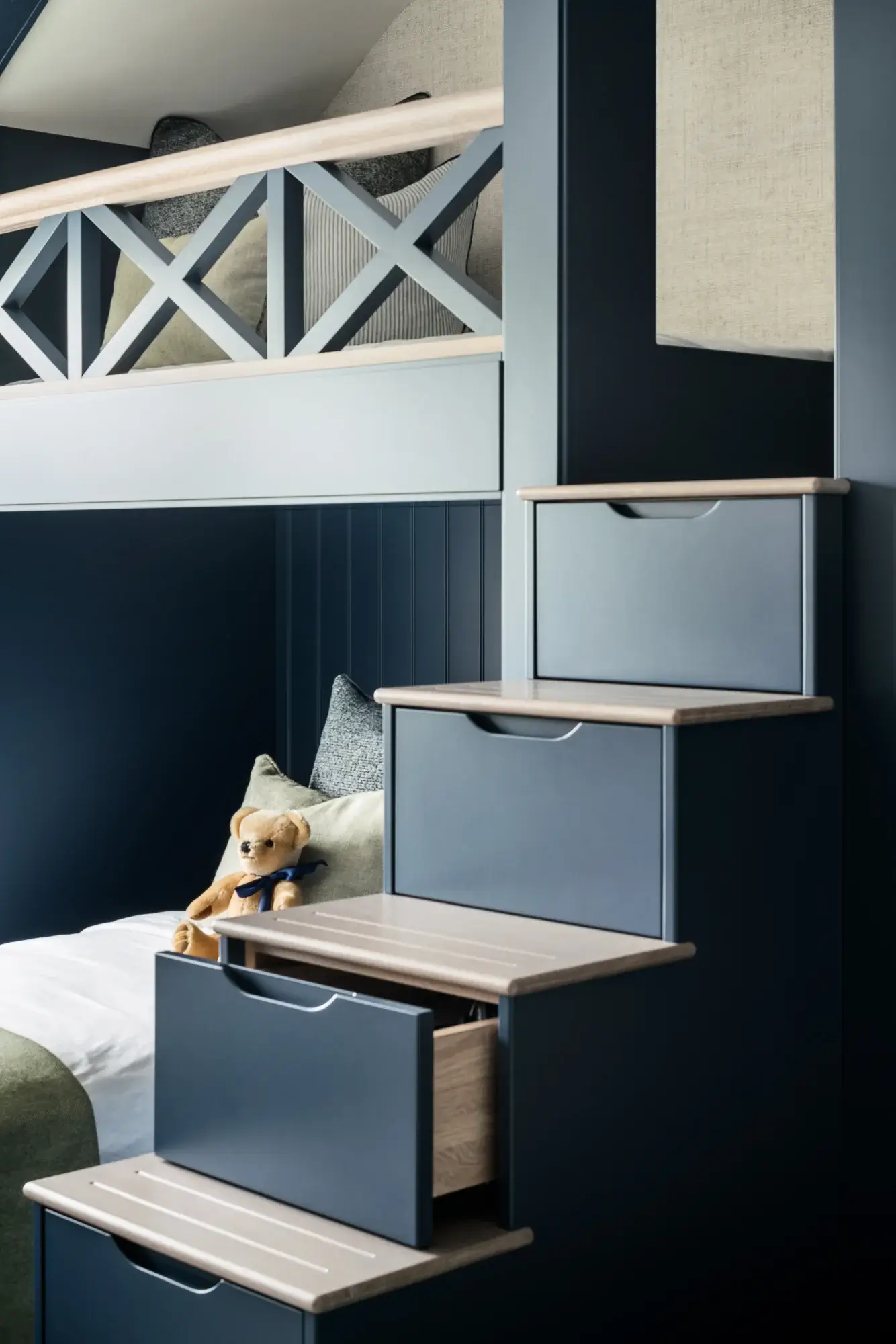 Wooden steps leading above the bed, with open hidden storage draw