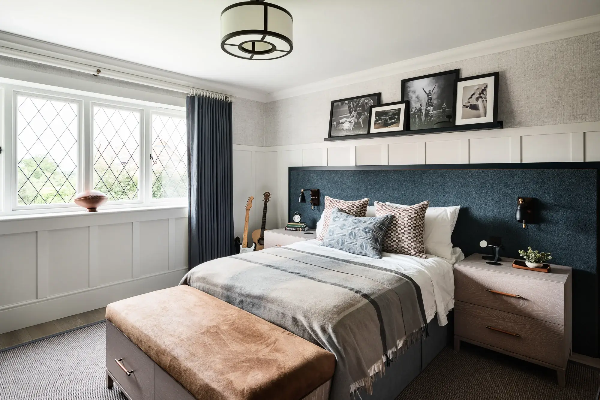 Bedroom with bed, guitars and a bespoke leather storage box