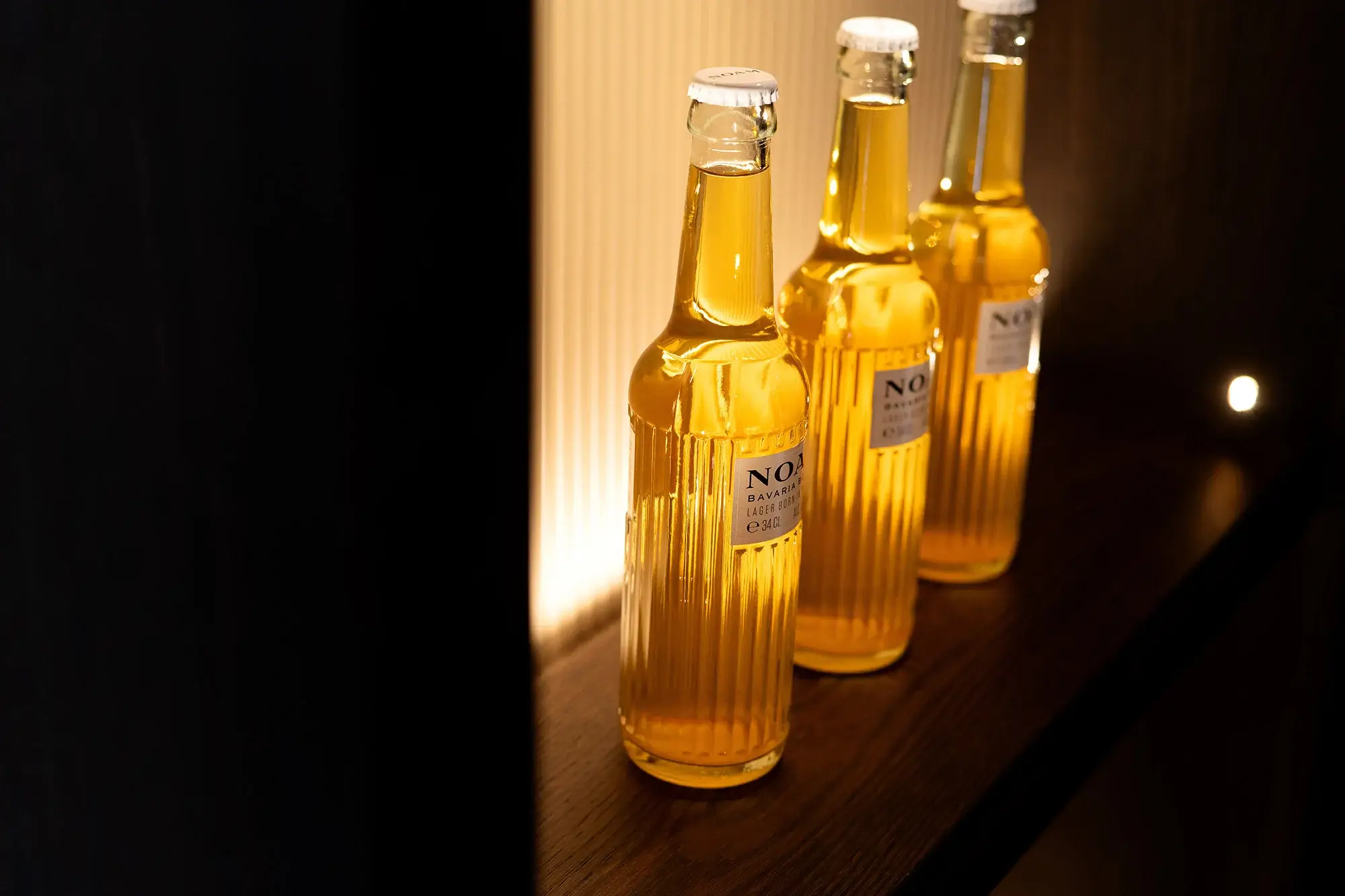 Beer bottles on a bespoke wooden shelf