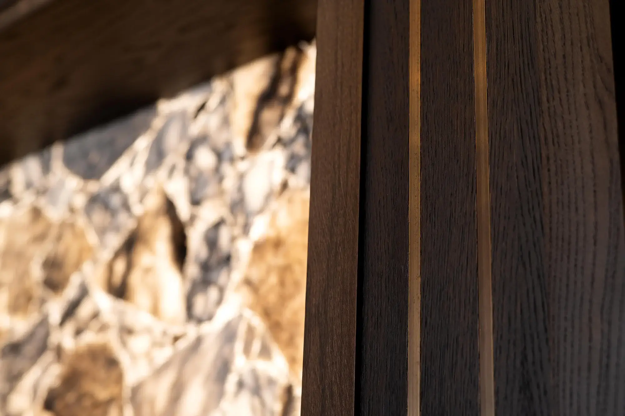 Close up shot of a wooden shelf unit with marble style backdrop