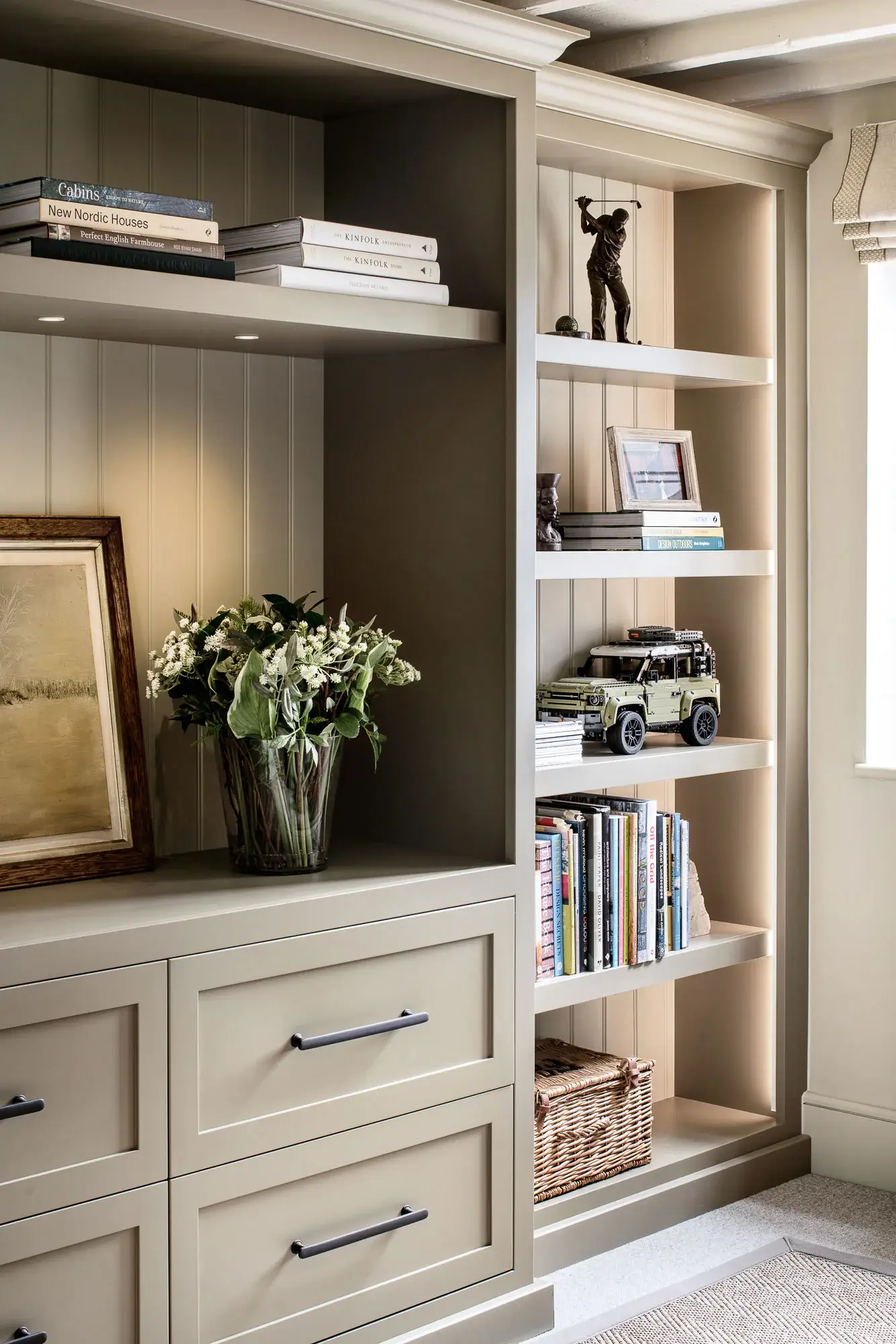 Built-in bookcase with painted wood finish, drawers, and open shelving, designed by Prenwood