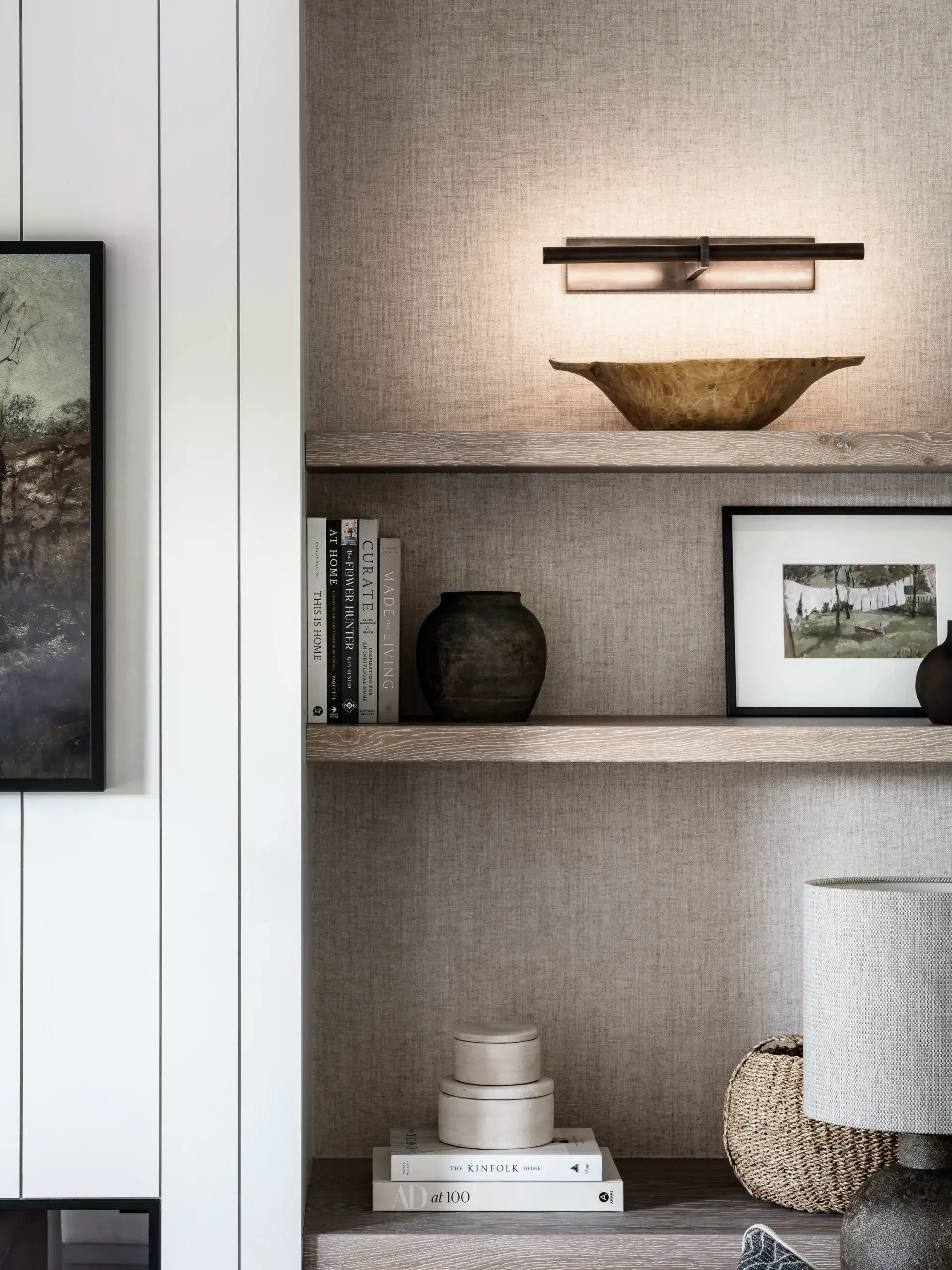 Timber shelving with integrated lighting and natural textures, styled with ceramics and books